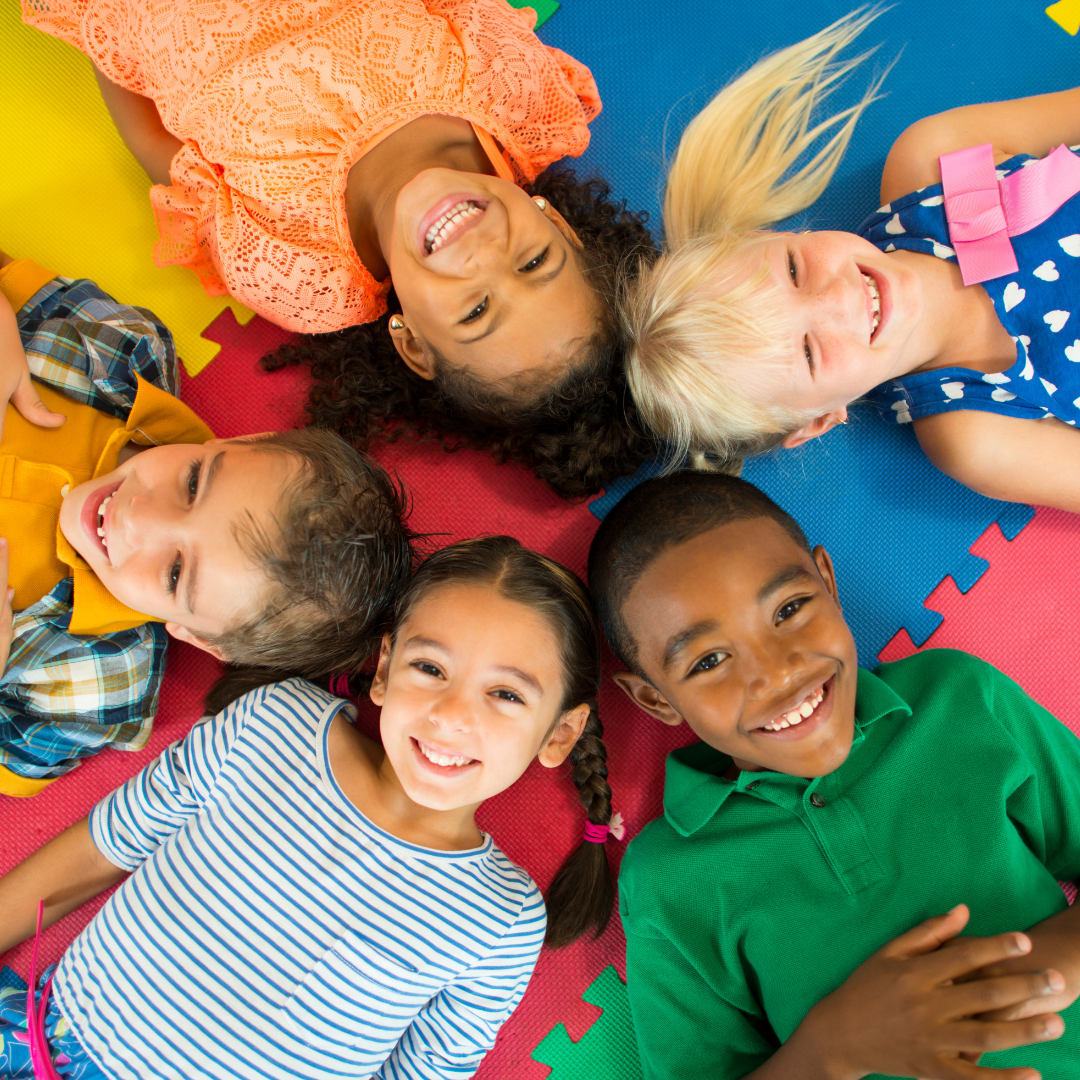 A group of happy preschoolers smiling for a photo