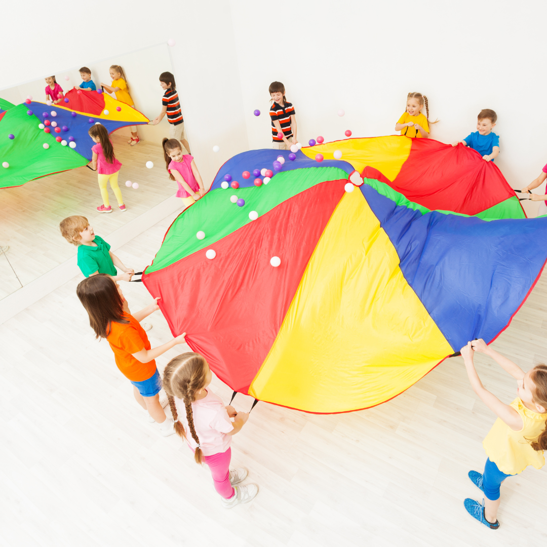 Preschoolers playing with a parachute and balls